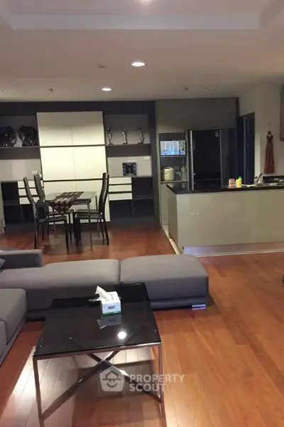 Spacious modern living room with open kitchen and elegant wooden flooring