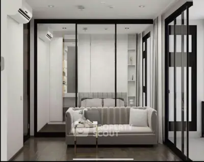 Modern living room with sleek design and glass partitions, featuring a cozy sofa and elegant decor.
