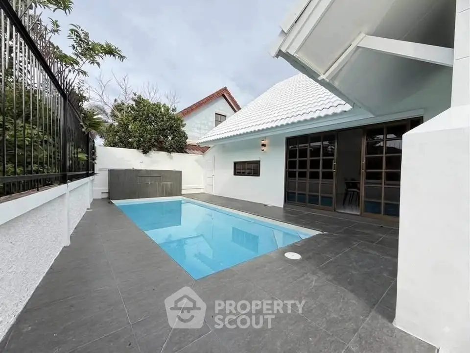 Charming modern home with sleek pool and stylish exterior design.
