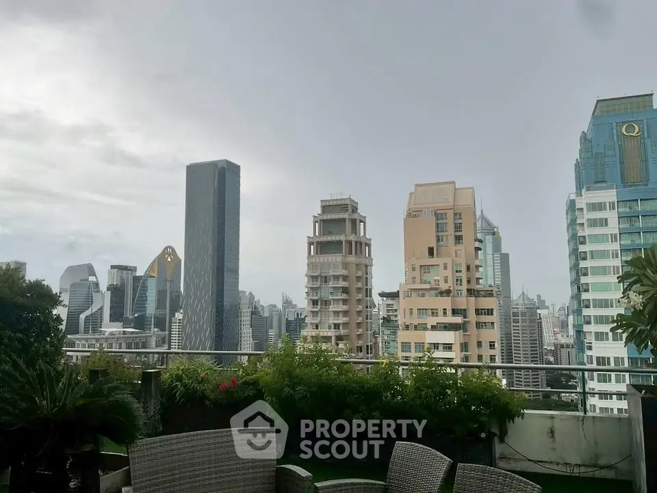 Stunning city skyline view from a lush rooftop terrace with modern seating.