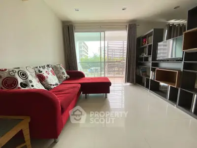 Modern living room with red sofa and balcony view in stylish apartment