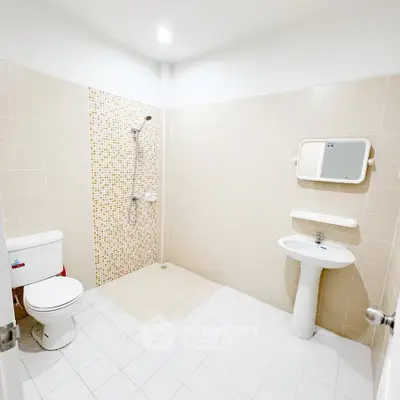 Modern bathroom with shower, toilet, and sink in a minimalist design.