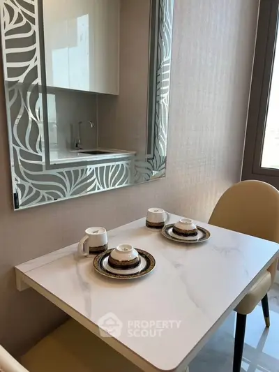 Modern kitchen with elegant table setting and stylish mirror