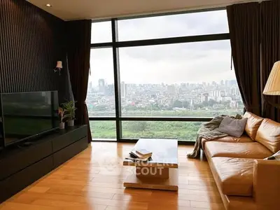Luxurious living room with panoramic city view and elegant furnishings.