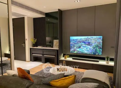 Modern living room with sleek furniture and large TV, perfect for relaxation.