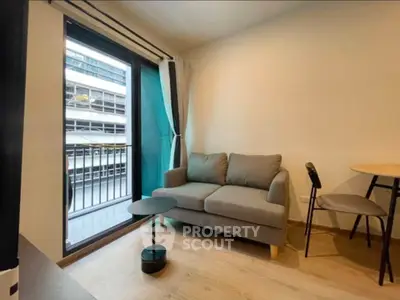 Cozy living room with balcony access in modern apartment