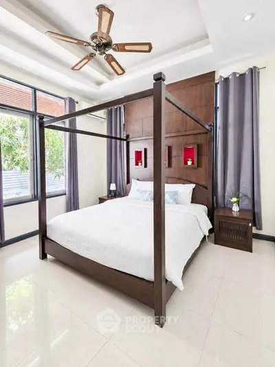 Luxurious bedroom with canopy bed and modern decor, perfect for relaxation and comfort.