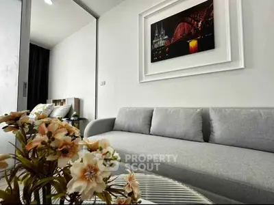 Modern living room with elegant gray sofa and stylish wall art, perfect for urban living.