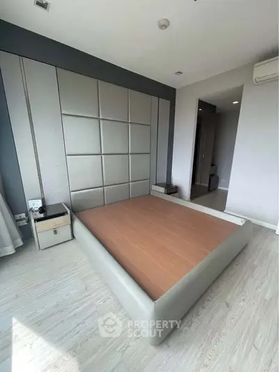 Modern bedroom with stylish panel wall and sleek wooden flooring