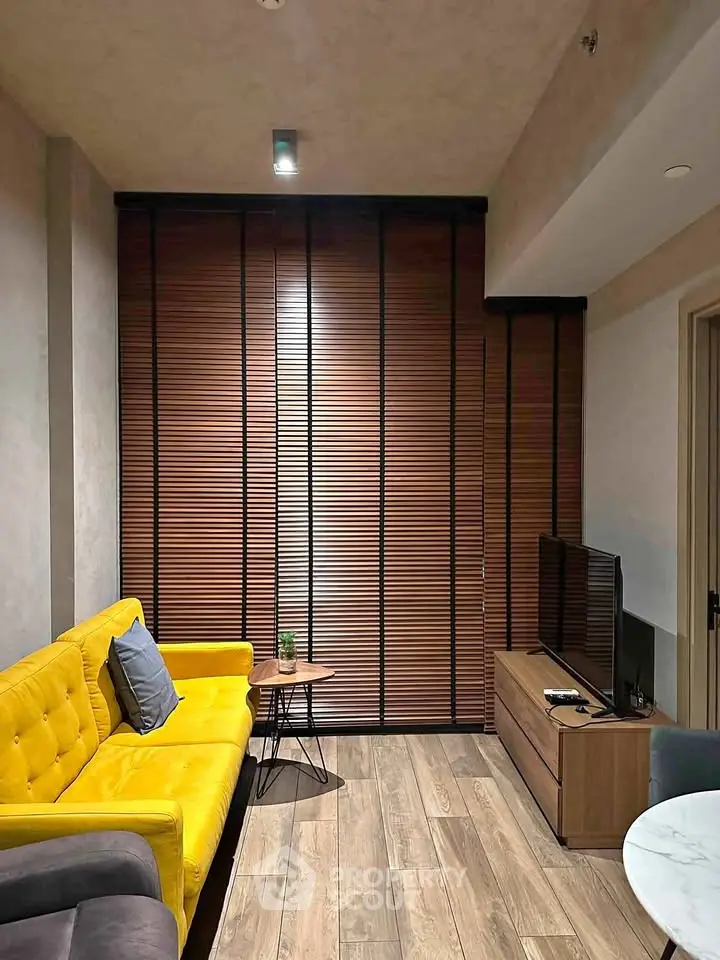 Modern living room with vibrant yellow sofa and sleek wooden blinds