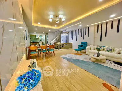 Spacious modern living room with elegant decor and open layout, featuring stylish furniture and ambient lighting.