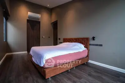 Modern bedroom with stylish decor and air conditioning in a contemporary home.