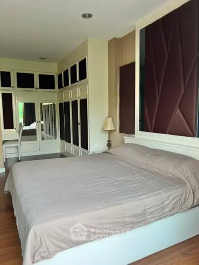 Spacious bedroom with elegant built-in wardrobes and cozy lighting