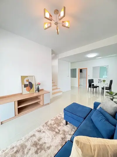 Modern living room with stylish blue sofa and elegant decor, perfect for relaxation and entertaining.