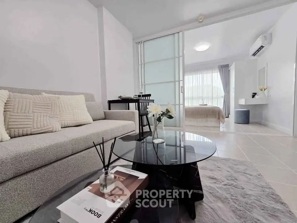 Modern open-plan living room with cozy sofa and stylish decor