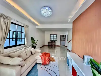 Spacious modern living room with elegant lighting and cozy seating area.