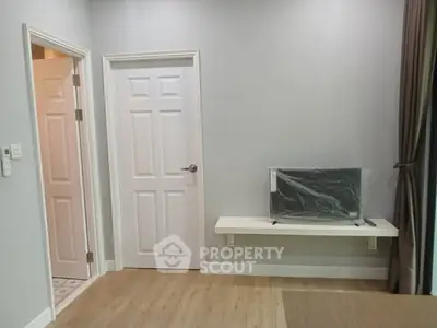 Modern living room with wall-mounted TV and elegant wooden flooring