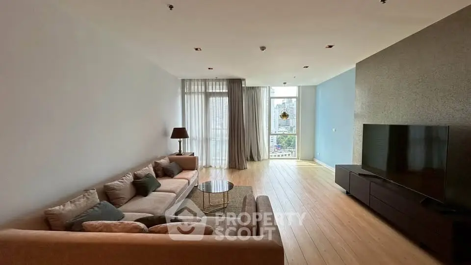 Spacious modern living room with large windows and stylish furniture in a high-rise apartment.