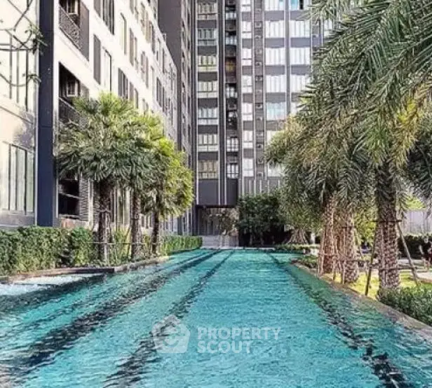 Luxurious residential building with a stunning outdoor pool and lush greenery.
