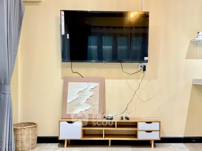 Modern living room with wall-mounted TV and stylish wooden cabinet