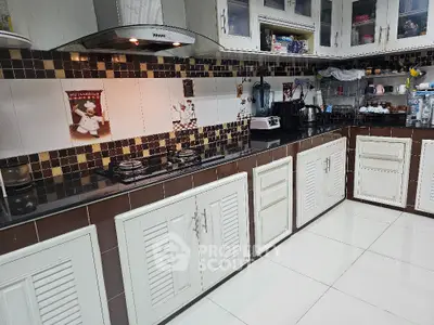 Spacious kitchen with modern gas stove and ample storage in elegant home