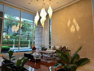 Luxurious living room with elegant lighting and garden view, perfect for relaxation and entertaining.