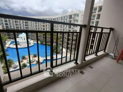 Spacious balcony with stunning pool view in modern apartment complex