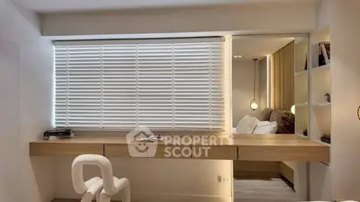 Modern study area with sleek desk and chair, featuring large window with blinds and cozy lighting.