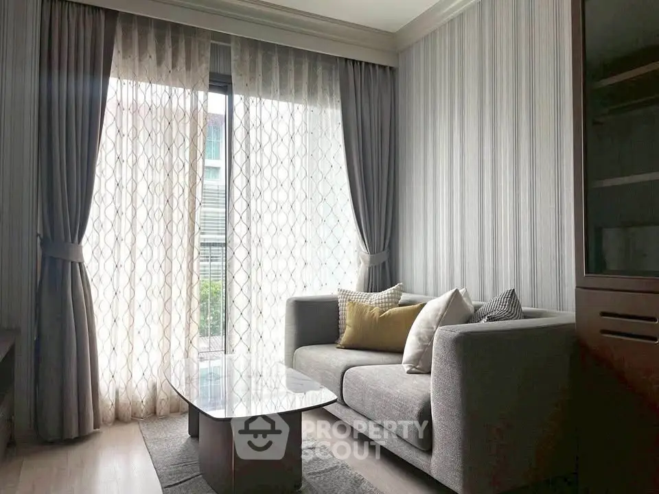 Elegant living room with modern sofa and floor-to-ceiling windows in a stylish apartment.