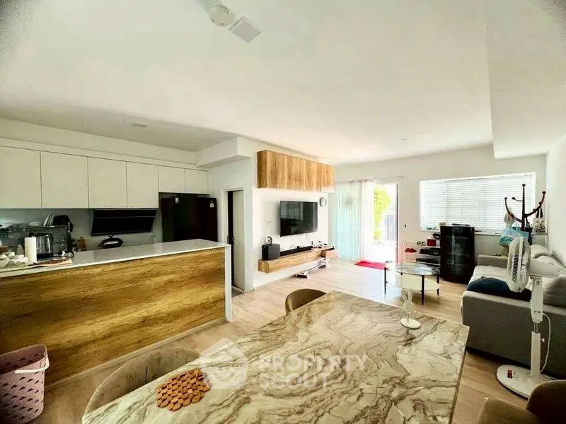 Modern open-plan living room with stylish kitchen and elegant decor