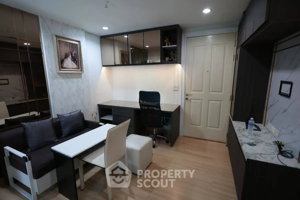 Modern living room with stylish furniture and elegant decor, featuring a cozy workspace and chic lighting.
