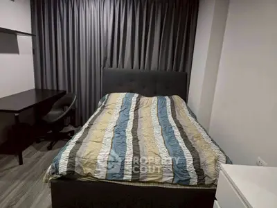 Cozy bedroom with modern decor and study desk, perfect for relaxation and productivity.