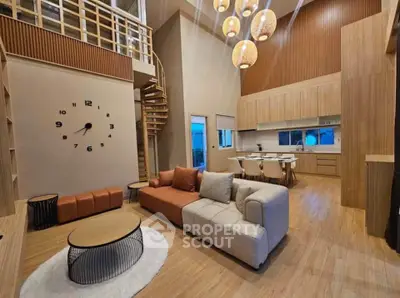 Stunning modern living room with high ceilings, spiral staircase, and elegant lighting in a stylish open layout.