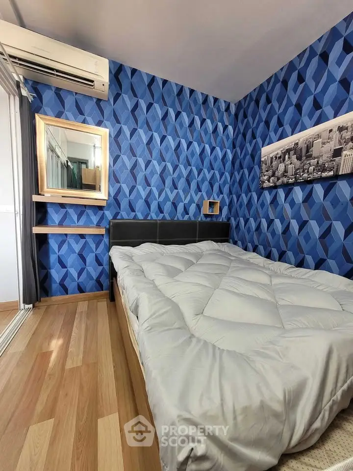 Modern bedroom with geometric blue wallpaper and cozy bedding