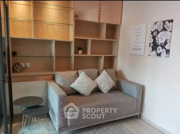 Cozy living room with modern sofa and stylish shelving, perfect for relaxation.