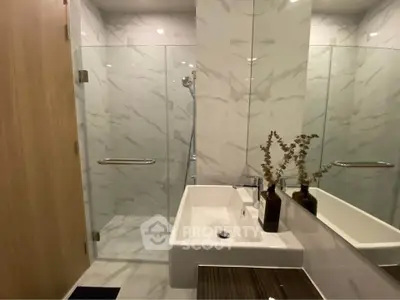 Modern bathroom with sleek glass shower and elegant sink design