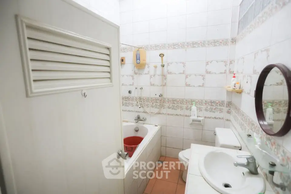 Cozy bathroom with bathtub and classic tile design, perfect for relaxation.