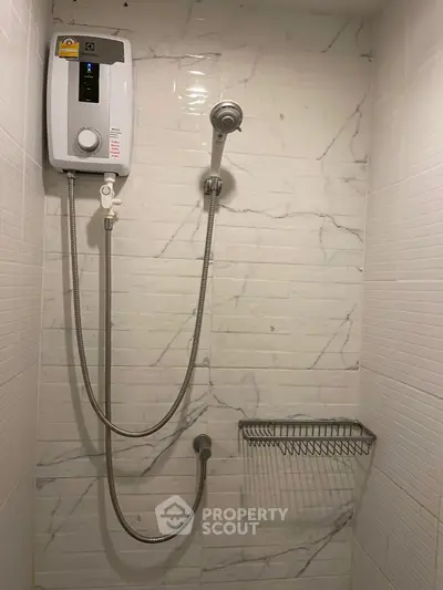 Modern bathroom shower with sleek white tiles and water heater