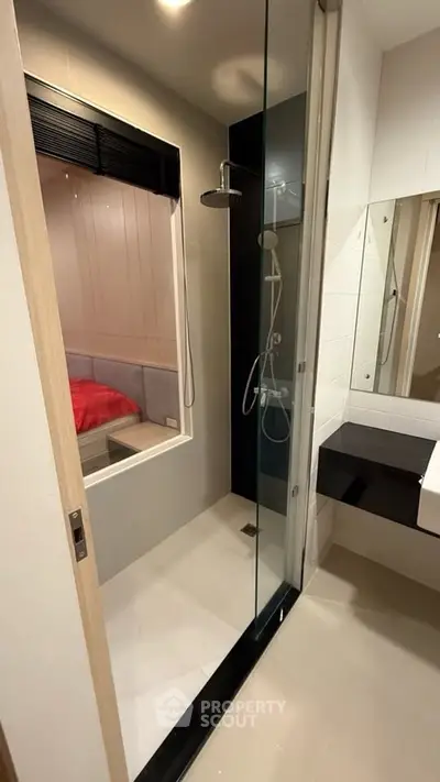 Modern bathroom with glass shower and sleek design in contemporary apartment.