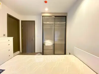 Modern bedroom with sleek wardrobe and minimalist design, perfect for urban living.