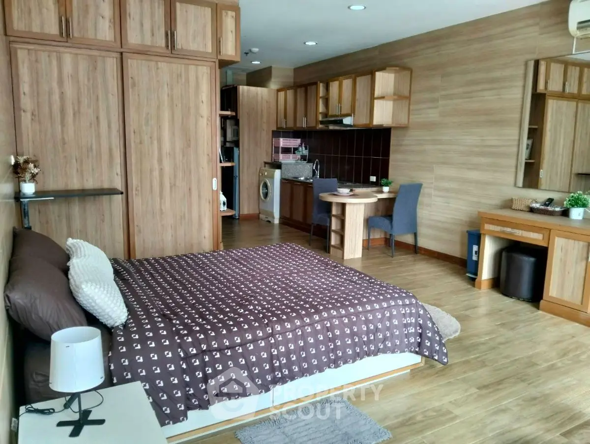Spacious studio apartment with modern wooden furnishings and cozy decor