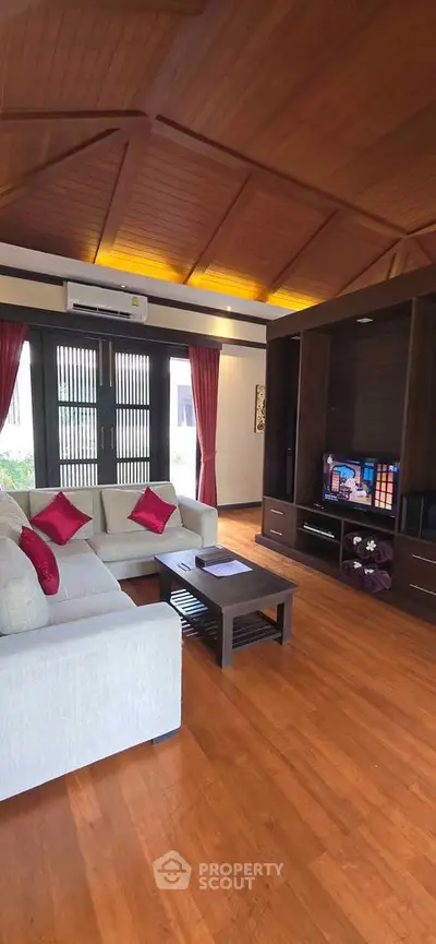 Luxurious living room with wooden ceiling and cozy seating area