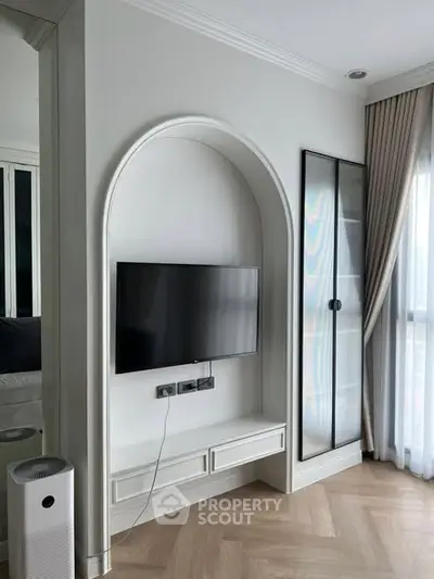 Modern living room with built-in TV unit and elegant glass cabinet