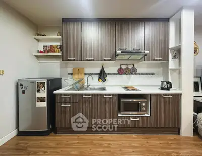Modern kitchen with sleek cabinetry and built-in appliances in a stylish apartment.