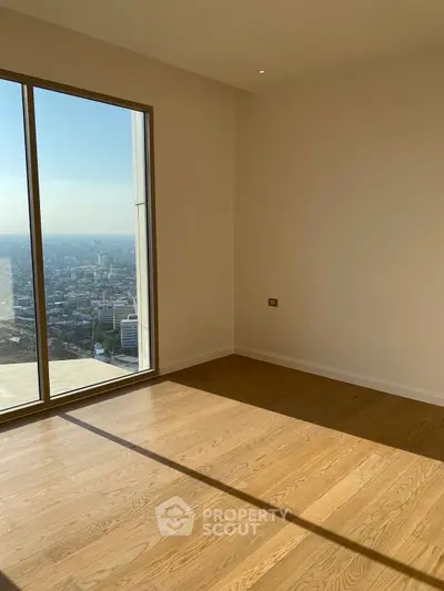 Spacious empty room with stunning city view and large window, perfect for customization.