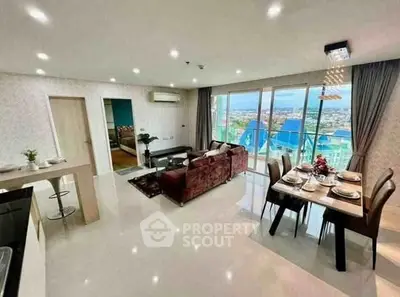 Luxurious open-plan living room with stunning city view and elegant dining area.
