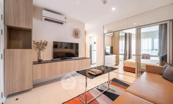 Modern living room with sleek furniture and integrated TV unit in a stylish apartment.
