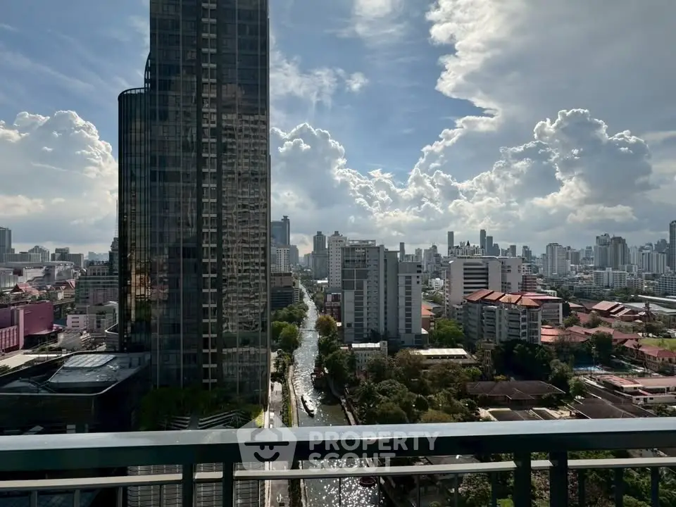 Stunning cityscape view from a high-rise balcony showcasing urban skyline and river.