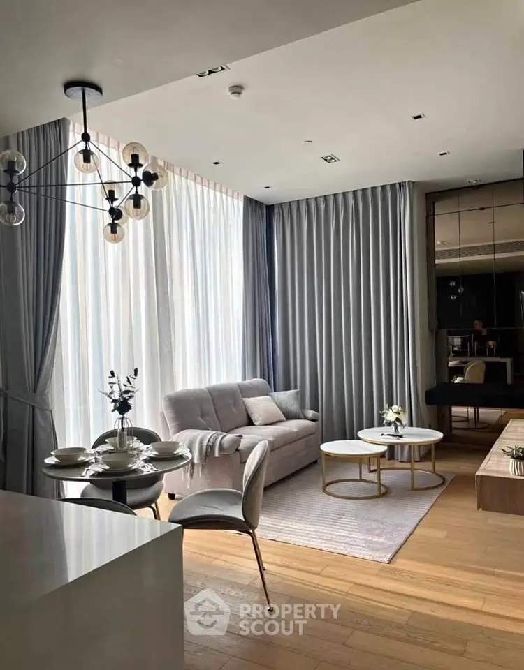 Modern living room with elegant decor, large windows, and stylish furniture in a cozy apartment.