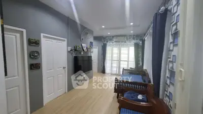 Spacious living room with modern decor and large windows for natural light.